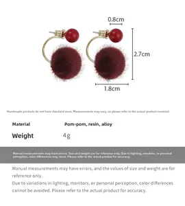 Detail view of red plush ball and resin bead earrings with clear size measurements