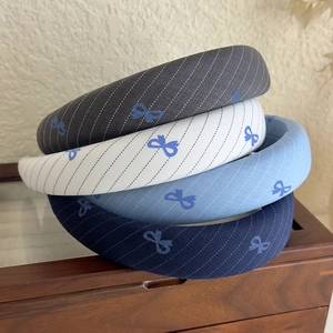 Set of four blue striped sponge headbands with cute bow patterns for women and girls