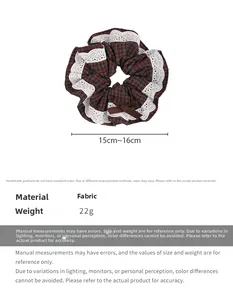 Detail view of British plaid hair scrunchie with lace trim and bow, size 15-16cm