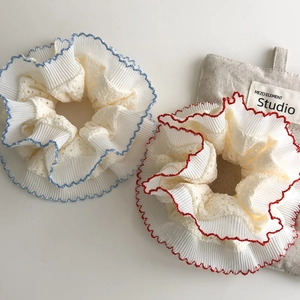 Handmade lace scrunchies with intricate hollow texture and decorative red and blue stitching