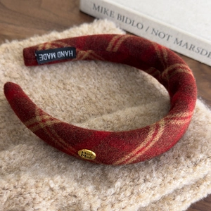 Close-up of red plaid thick headband with hand made tag and heart metal buckle