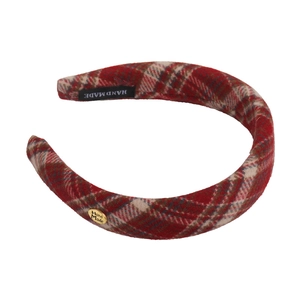 Padded red plaid wool headband with gold handmade tag and a high-top design