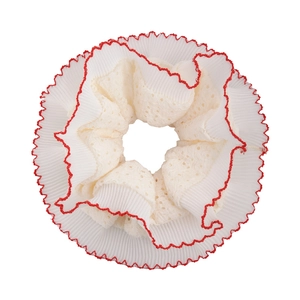 Oversized cream scrunchie with red wavy edges and embroidered eyelet lace texture
