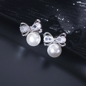 Elegant bow-knot pearl earrings with micro-set zircons on silver metallic base