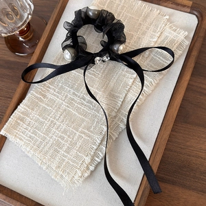 French vintage black lace scrunchie with pearls and heart charm on white tweed fabric