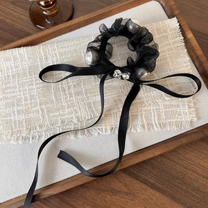 Elegant black mesh scrunchie with long satin ribbons and large white pearls for ponytail