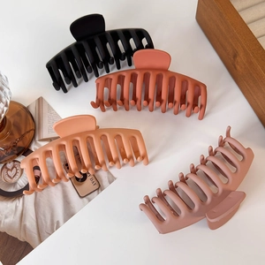 Set of four large matte hair claw clips in elegant earth tones for thick hair styling