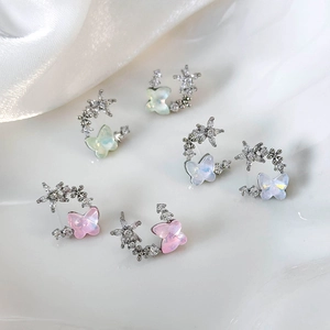 Three pairs of niche butterfly and flower stud earrings in pink, green, and purple