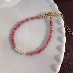 Detail of pink crystal beads and white pearls bracelet with a gold lobster clasp