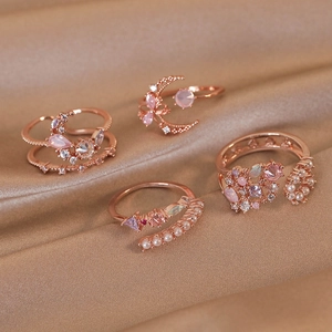 Rose gold adjustable rings set with pearl, pink crystals and floral moon designs