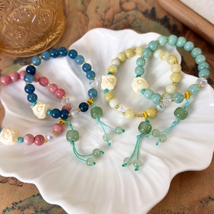 Ethnic style beaded bracelets with rose carving and tassel in shell ceramic dish