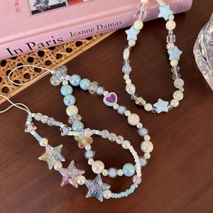 Detailed view of handmade beaded phone charms with sea salt blue stars and pearls