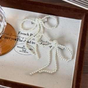 Elegant French style pearl bow hair clips set with silver metal duckbill base on tray