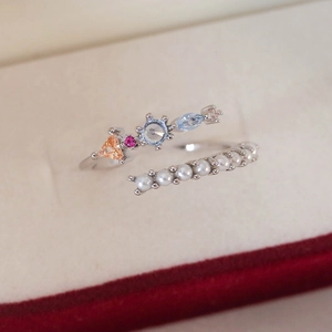 Macro detail of adjustable ring with colorful gemstones and elegant white pearls