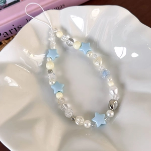 Detailed macro shot of summer blue star beaded phone charm with sea salt theme accents
