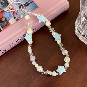 Close-up of handmade sea salt blue star beads and pearls on a stylish mobile phone strap