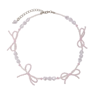 Pastel beaded bow choker with pink crystals and heart pearls on white background