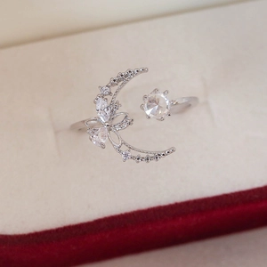 Close-up of adjustable silver ring featuring crescent moon and star zircon details