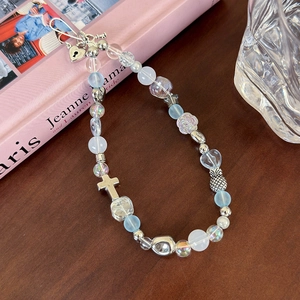 Macro view of blue sea salt beads and metallic star charms on a wooden surface