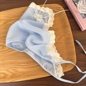 Detail of blue gingham headscarf featuring delicate floral lace trim and heart applique