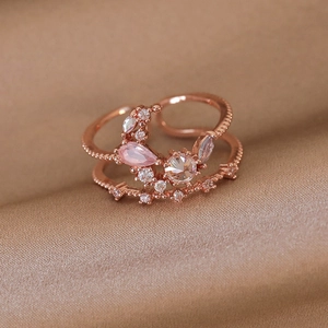 Detail of rose gold double-layer open ring with pink zircons on velvet background