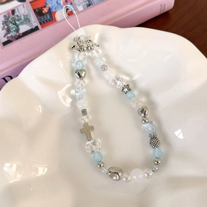 Detailed view of sea salt blue beaded phone strap with silver cross and heart charms