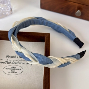 Detail of blue denim and white mesh braided headband on a premium jewelry box display