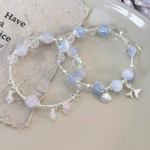 Beaded shell and fish tail charm bracelets with colorful glass beads and floral accents