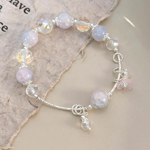 Detail view of purple and blue floral crystal beaded bracelet with silver flower charms