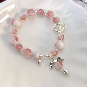 Close-up of pink crystal bead bracelet with silver heart and angel wing charms