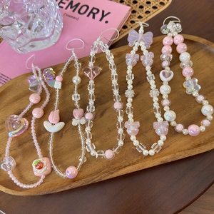 Handmade pink beaded phone wrist straps with floral and bow charms in ins style