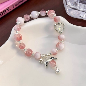 Detail view of pink and white crystal beaded bracelet with silver angel wing charms