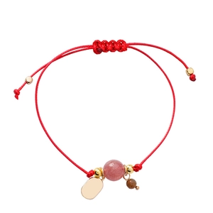 Handmade red braided cord bracelet with strawberry quartz bead and gold charm tag