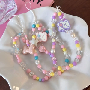 Detailed view of colorful macaron beads featuring star and bear charms on a mobile phone chain