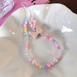 Detail of colorful beaded phone strap with resin bow and transparent butterfly charm