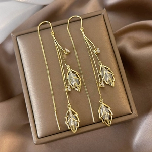 Elegant gold leaf tassel earrings with cat eye stone and cubic zirconia charms