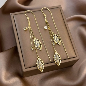 Elegant gold leaf earrings with white cat eye stone and long chain tassels for women