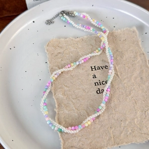 Close-up of double-layer beaded necklace with colorful seed beads and white pearls