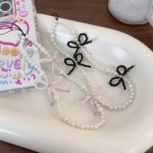 Three-piece Korean style pearl phone straps featuring sweet pink and black beaded bows