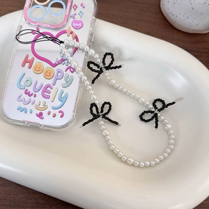 Phone case with white pearl strap, black bead bows and colorful artistic graffiti art