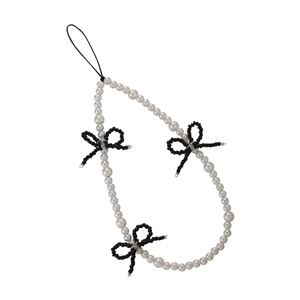 Handmade beaded phone strap with white pearls and black woven bows on white background