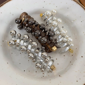 Three elegant pearl spiral telephone wire hair ties in brown, clear and white finishes