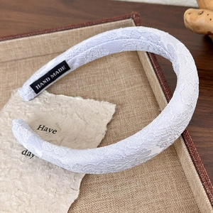Detailed macro view of the handmade blue lace headband with premium hand-made label