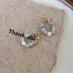 Handmade gold hoop earrings featuring light blue natural stone beads and a fresh water pearl