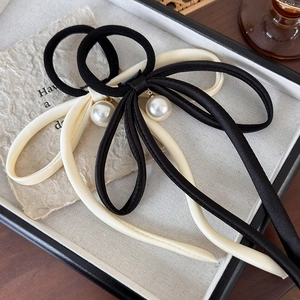 Elegant satin bow hair ties with pearl pendants in black and cream colors