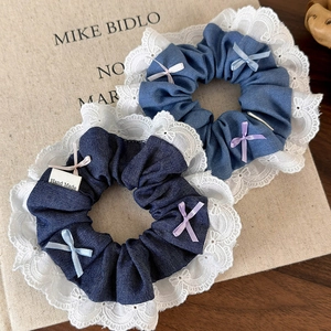 Blue denim hair scrunchies with white lace edges and colorful ribbon bows in two shades