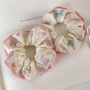 Pink cherry and bow embroidery cotton scrunchies set for women on white book background