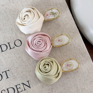 Three-piece satin rose flower hair clips in beige pink and green with gold metal base