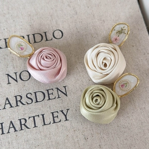 Three satin rose hair clips in pink white and green with vintage floral metal frames