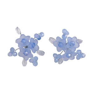 Handmade light blue flower stud earrings with beads and crystals on white background